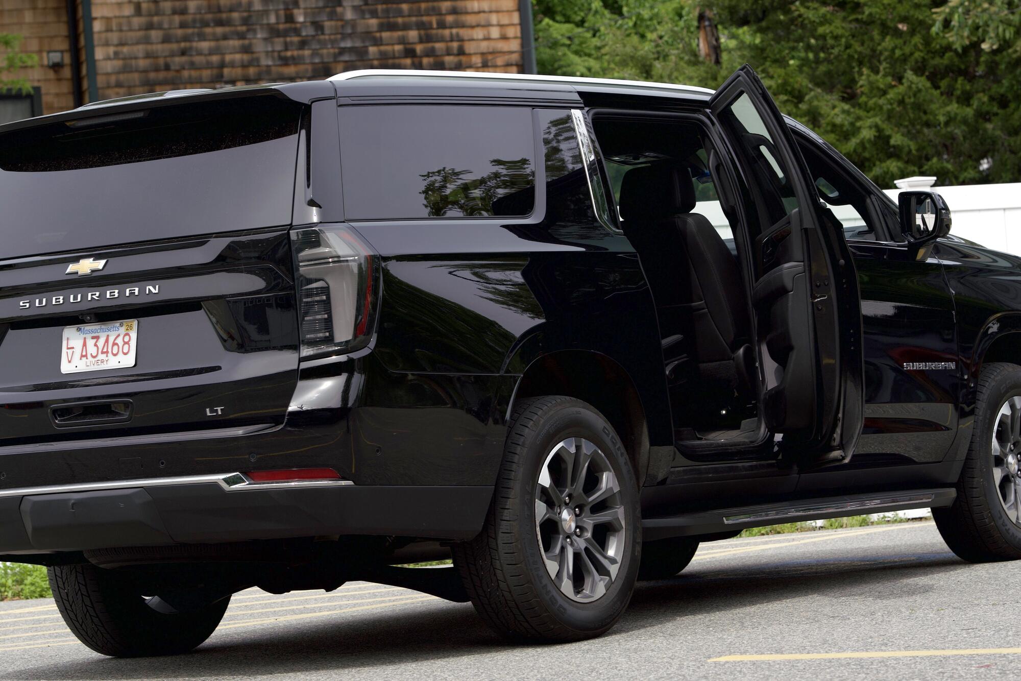 Black Chevrolet Suburban with the passenger door open